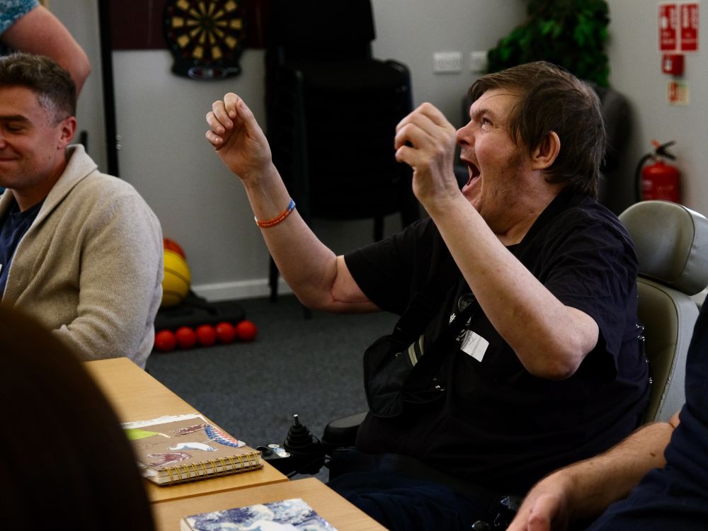 A man is raising his hands in the air in celebration
