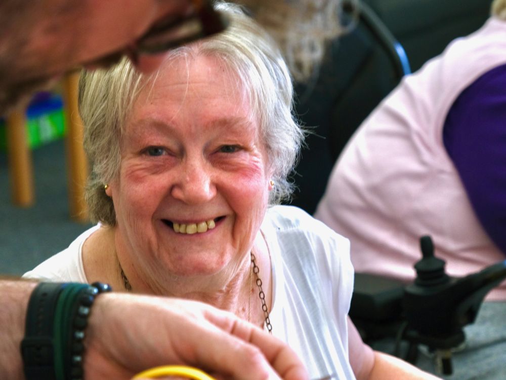 A smiling woman in white t-shirt