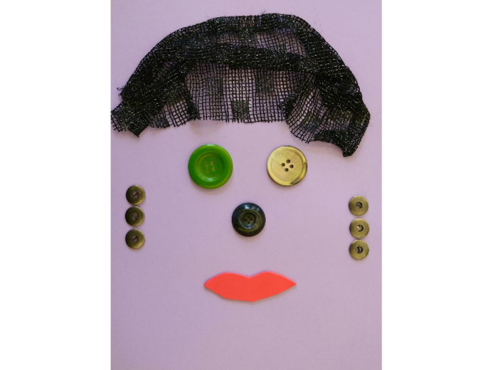A collage on purple paper of a woman's face. Her eye's are buttons. Her hair is black lace